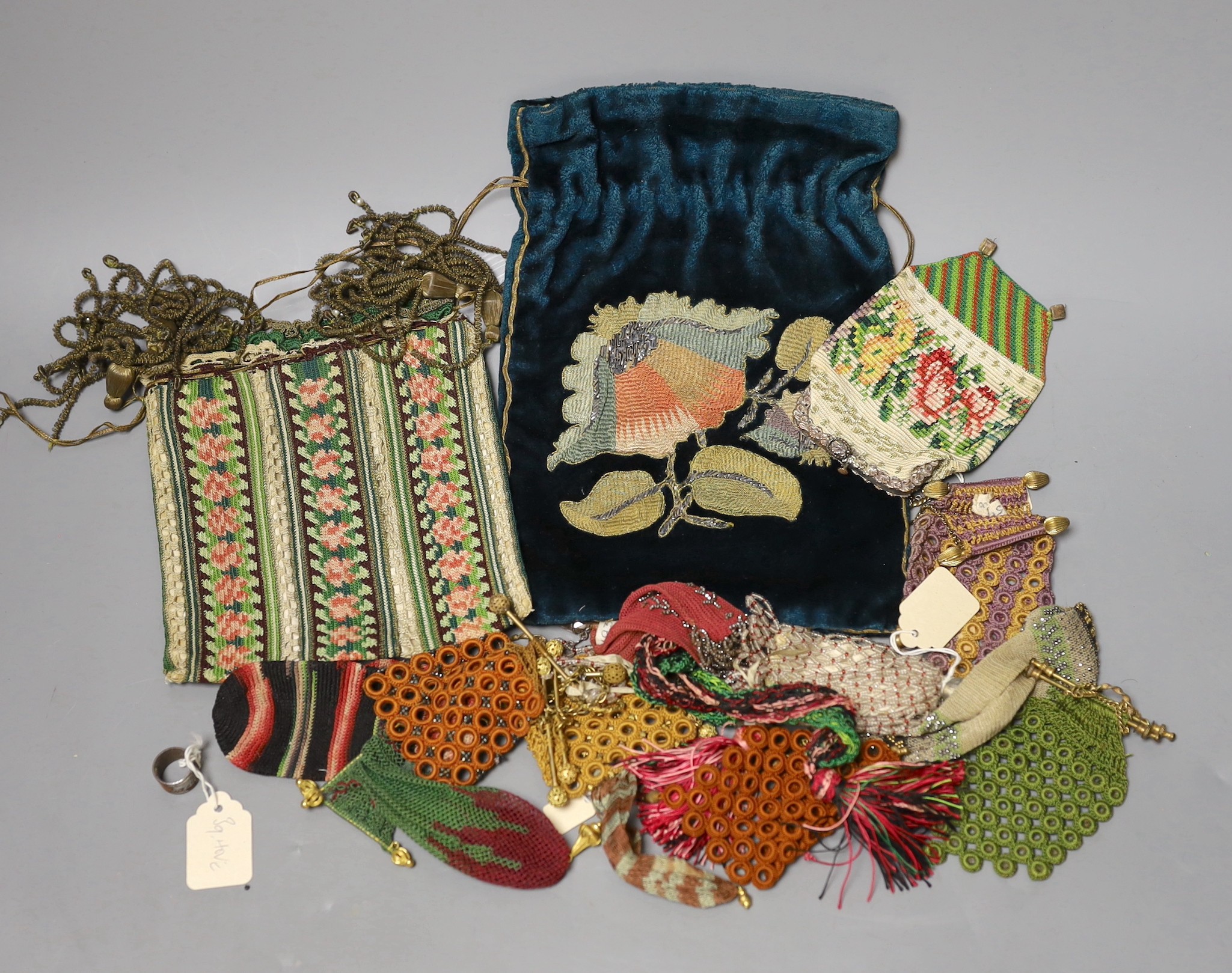 A late 19th century embroidered bible bag another smaller finely knitted bible bag, eight hand worked purses, a floral knitted purse, three misers purses and a novelty “jug” shaped purse,(15)